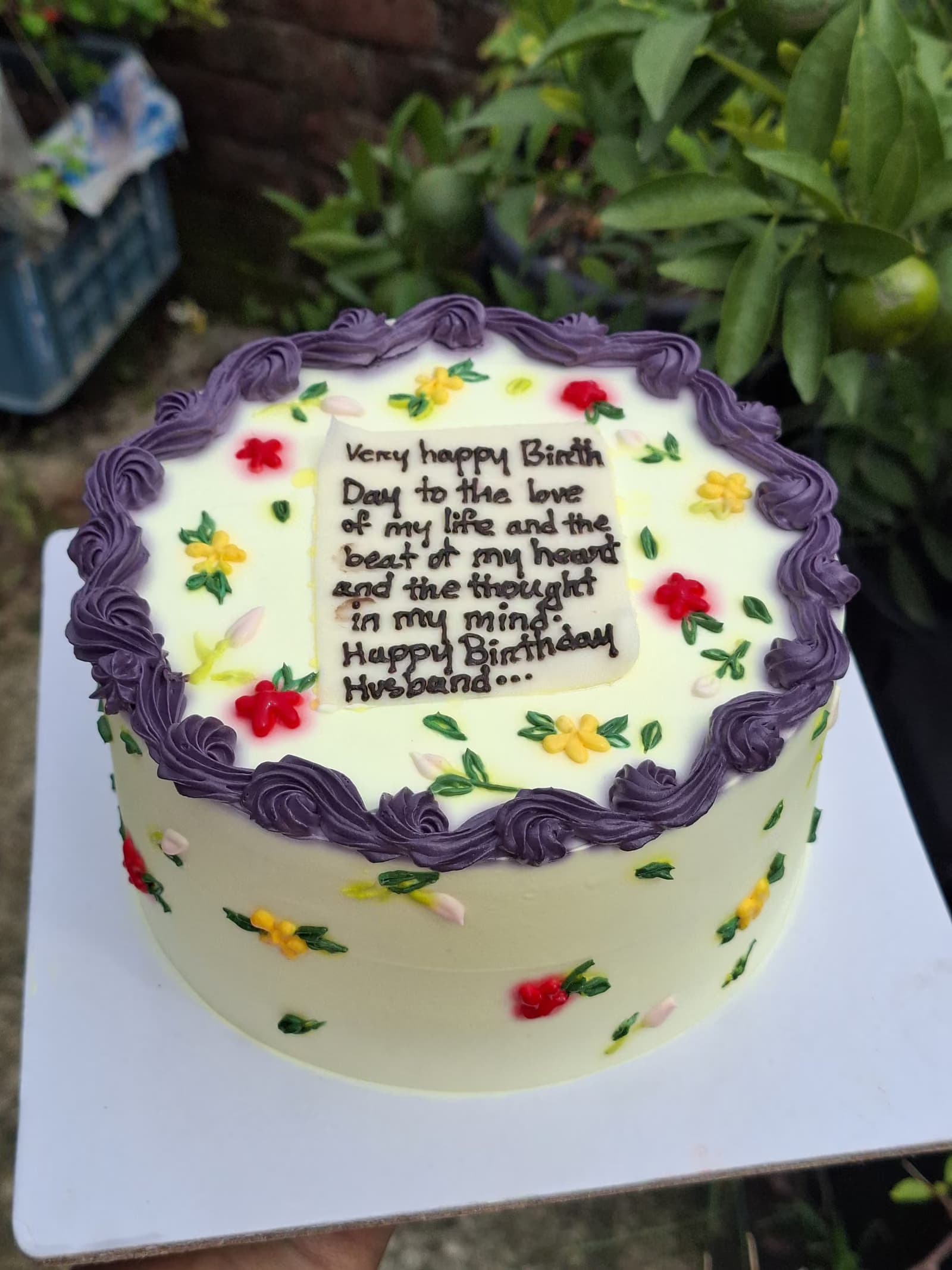 Floral message cake with a piped border