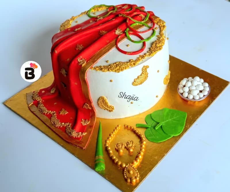 Red saree and gold jewellery cake