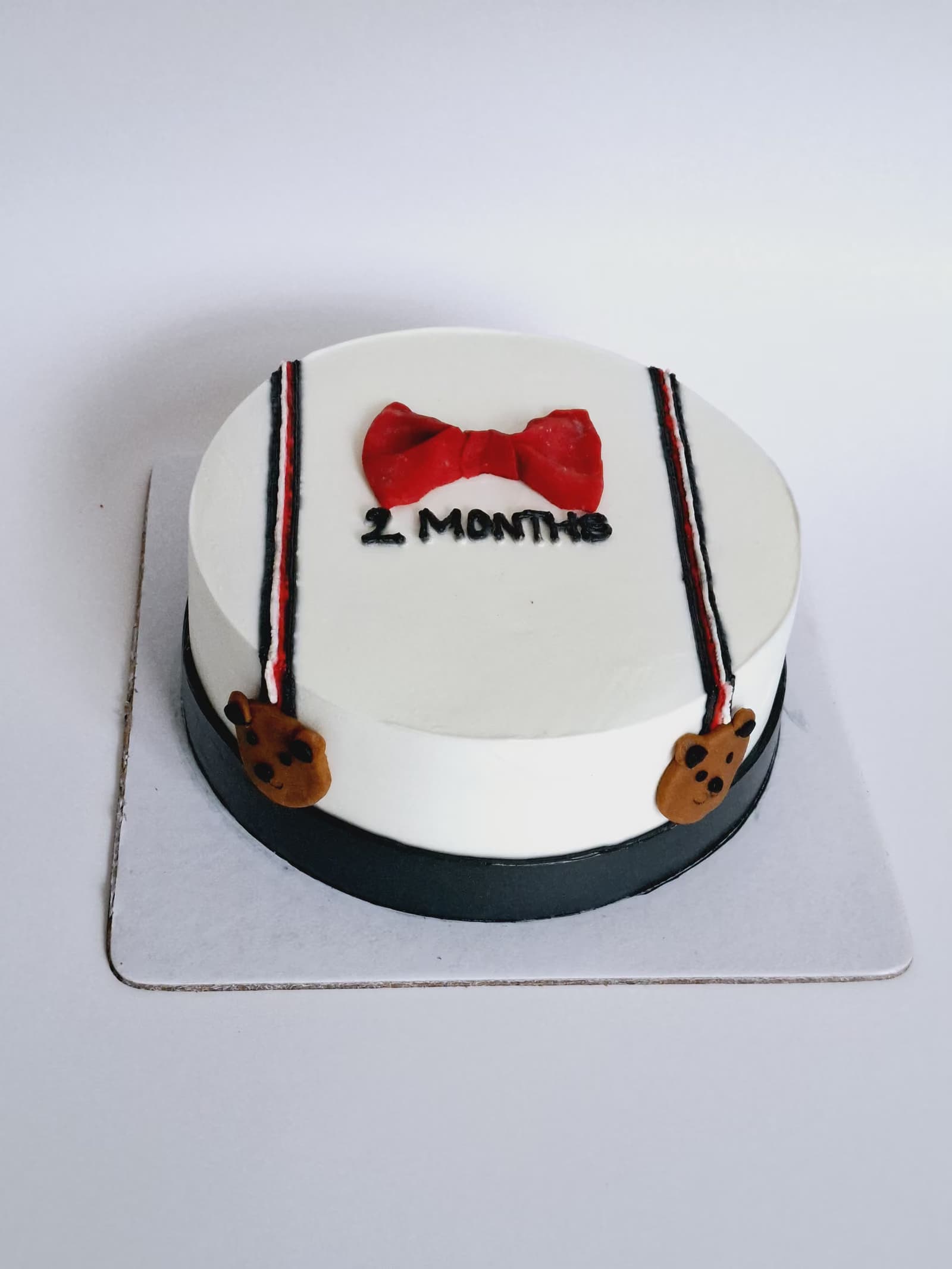 Two-month milestone cake with a bow tie