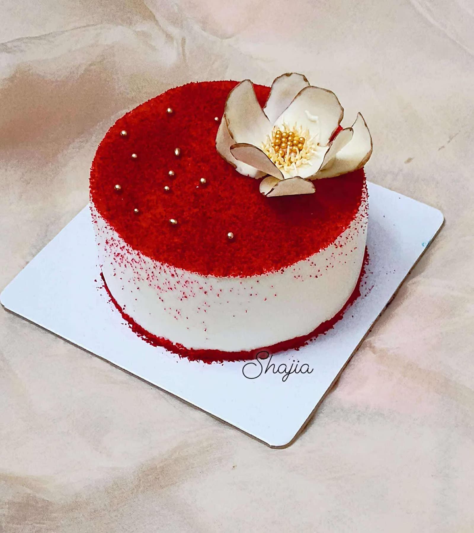 Red velvet cake with a sugar magnolia