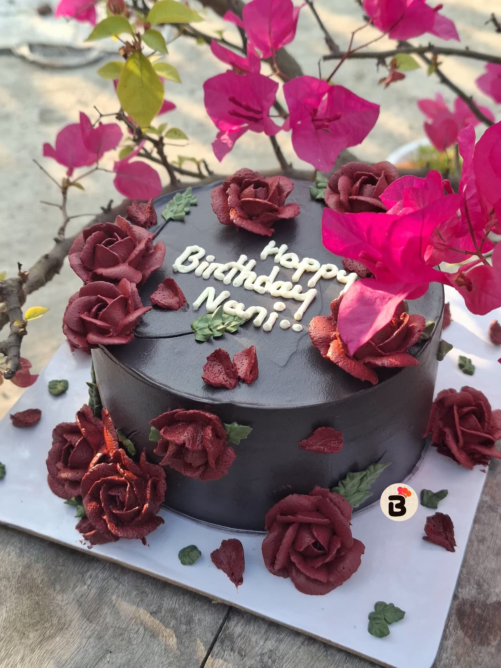 Black cake with burgundy roses