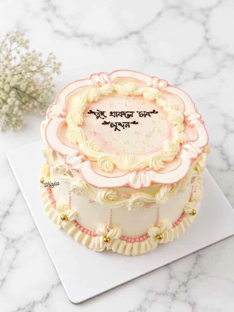 Vintage piped birthday cake in peach